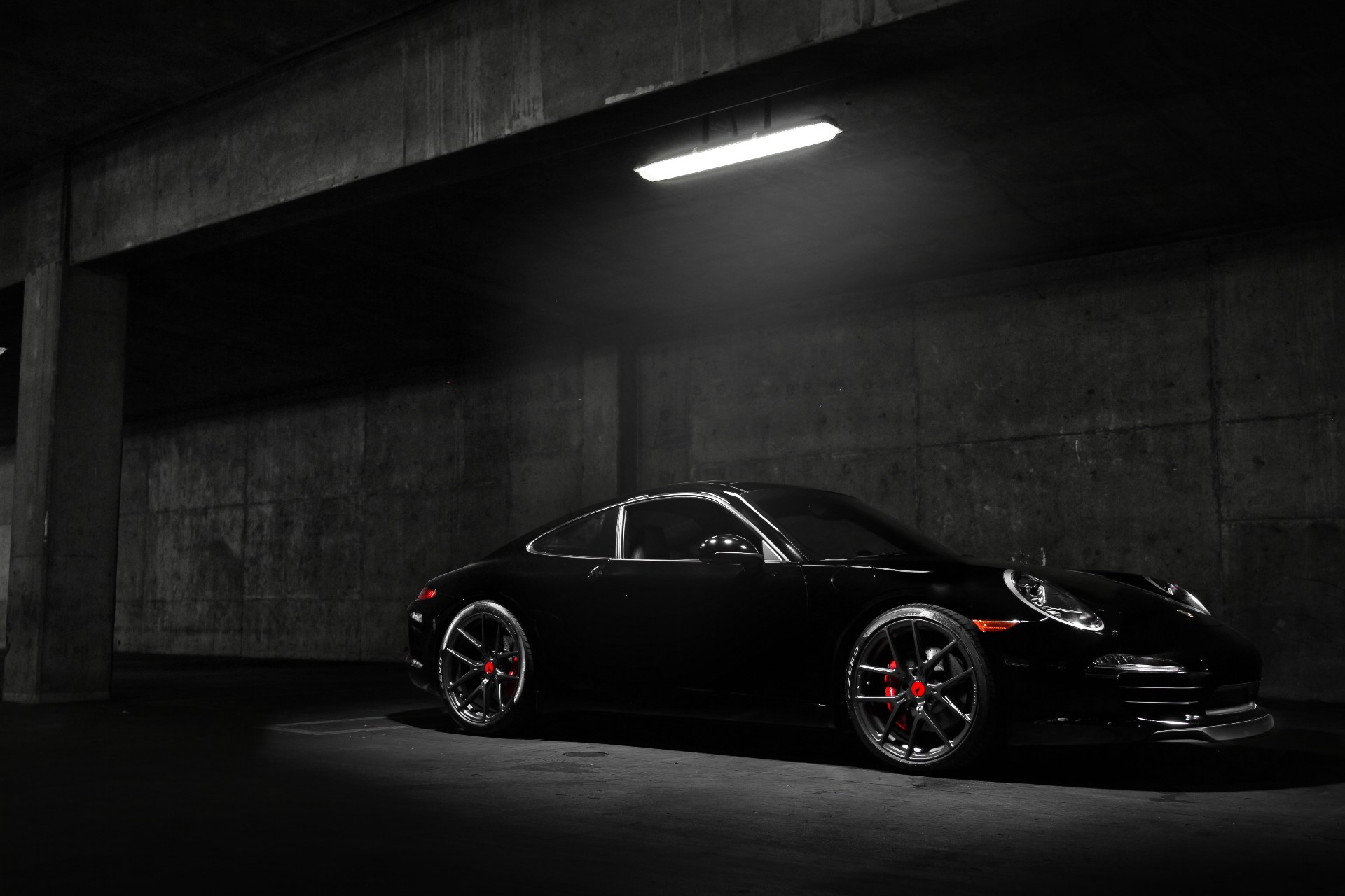 Black Porsche sports car in dramatic lighting